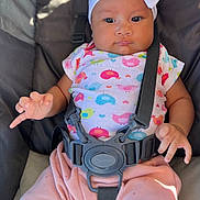 Ellamae is registered to the contest to win money with this photo: baby, child, infant, headband, bow, colorful_clothing, bird_pattern, stroller, harness, sitting, pink_pants, cute, curious, secure, soft_lighting, chubby_cheeks, hand, portrait, comfort, indoors