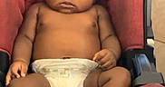 Amari is registered to the contest to win money with this photo: baby, infant, car_seat, diaper, child, serious, indoors, person, seat_belt, foot, hand, skin, head, black_hair, expression, cute, young, toddler, seat, floor_tiles