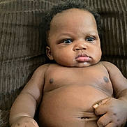 Amari joined the competition — help win amazing prizes! baby, infant, child, skin, face, eyes, hand, torso, couch, furniture, indoors, expression, curious, relaxing, chubby, portrait, young, person, human, sitting