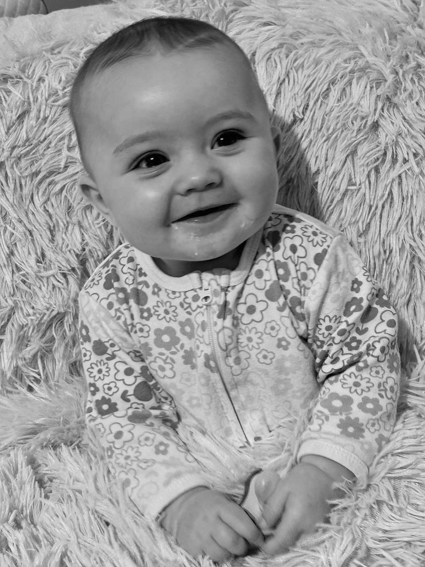Raven joined the competition — help win amazing prizes! baby, smiling, infant, onesie, floral_pattern, blanket, cozy, portrait, black_and_white, happy, cute, child, sitting, hands, face, young, indoors, soft_texture, closeup, warm
