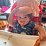 toddler, child, high_chair, pizza, food, bowl, eating, smiling, indoor, kitchen, clothing, face, hand, tray, snack, cheese, table, seat, person, playful