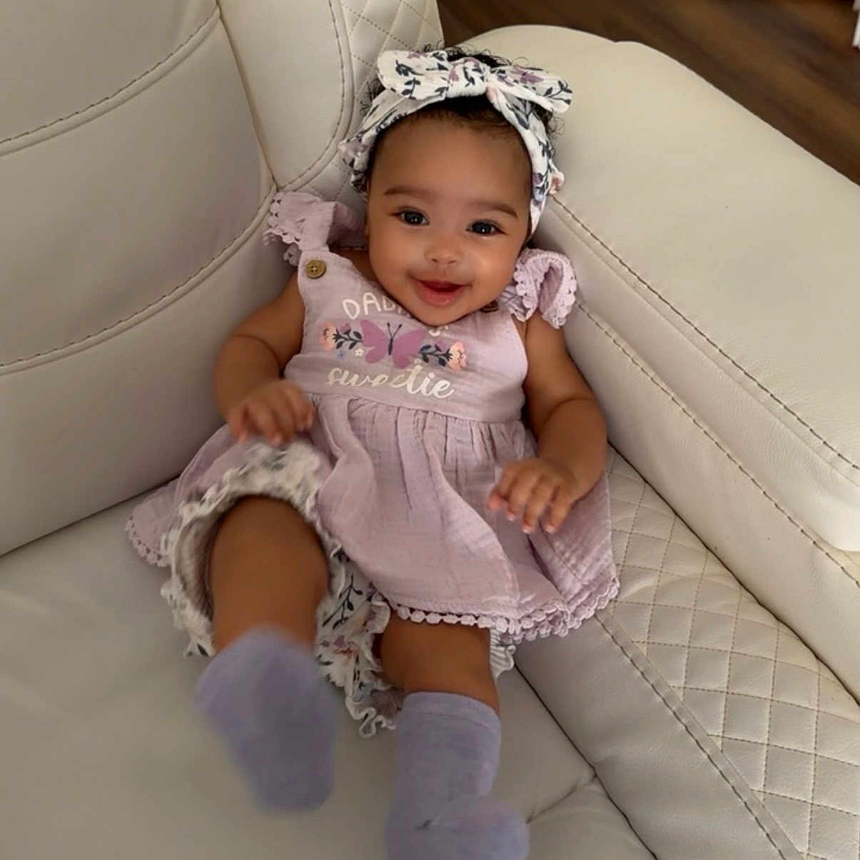 Raelynn joined the competition — help win amazing prizes! baby, girl, smiling, dress, headband, couch, leather, happy, infant, playful, socks, indoor, child, cute, fashion, portrait, seat, kicking, furniture, home
