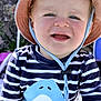 toddler, child, smiling, hat, striped_shirt, shark_graphic, outdoor, sunlight, blue_eyes, happy, cute, baby, face, clothing, summer, playful, portrait, fun, person, headwear
