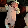 Aurora is registered to the contest to win money with this photo: newborn, baby, sleeping, pink_outfit, headband, bow, person, arm, hand, blanket, phone, tattoo, cozy, indoor, infant, cute, soft_lighting, rest, clothing, human