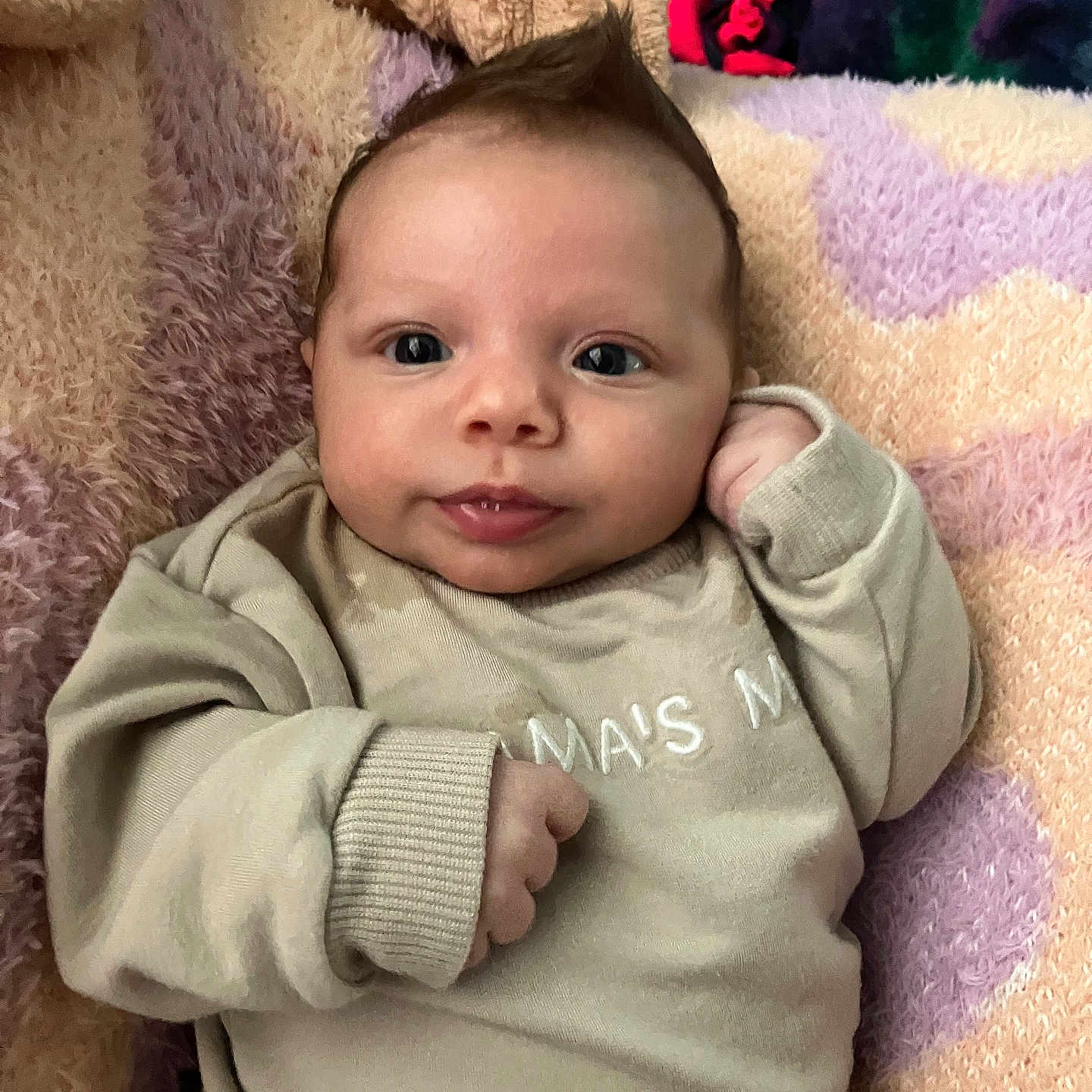Aurora joined the competition — help win amazing prizes! baby, blanket, child, clothing, cozy, cute, expression, face, hair, head, indoors, infant, lying_down, mohawk, person, portrait, skin, smile, soft_texture, sweater