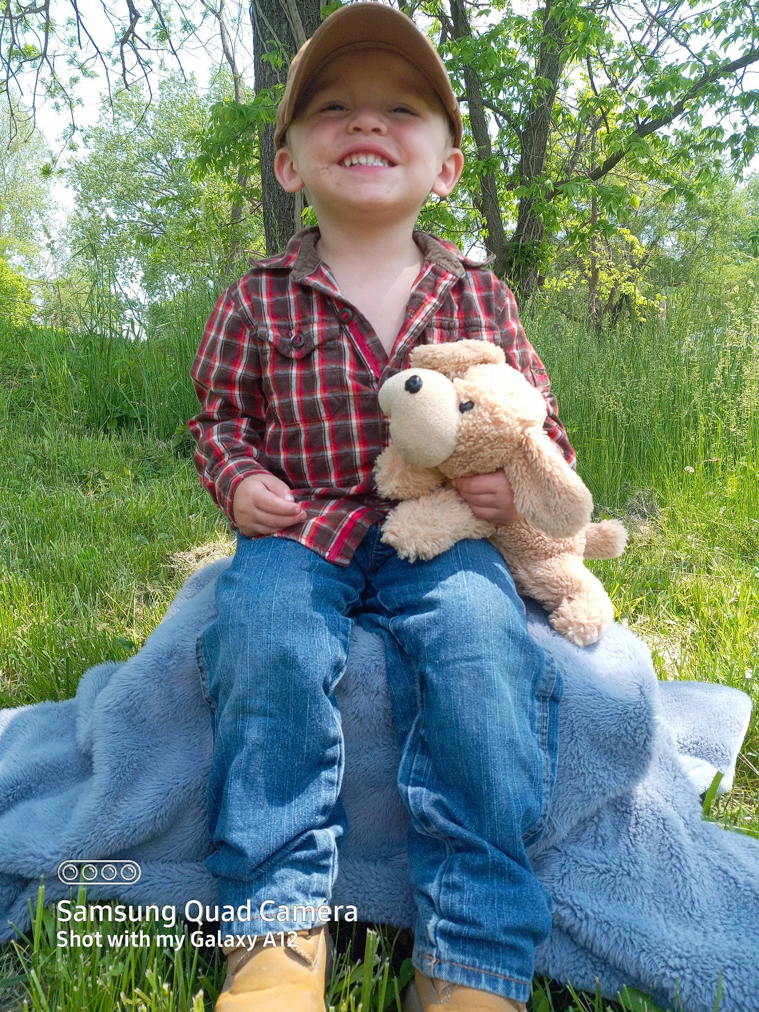 Bellamy joined the competition — help win amazing prizes! baby_toddler_clothing, child, fawn, fun, grass, happy, hat, headwear, jeans, joy, leaf, people, people_in_nature, person, plaid, plant, smile, sun_hat, tartan, textile