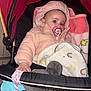 Célina -Marie a rejoint le concours — aidez-le/la à gagner de superbes lots ! baby, child, stroller, blanket, pacifier, jacket, hood, plush_toy, pink, red, black, indoor, cute, infant, hand, face, warm_clothing, comfort, sleepy, soft_toy