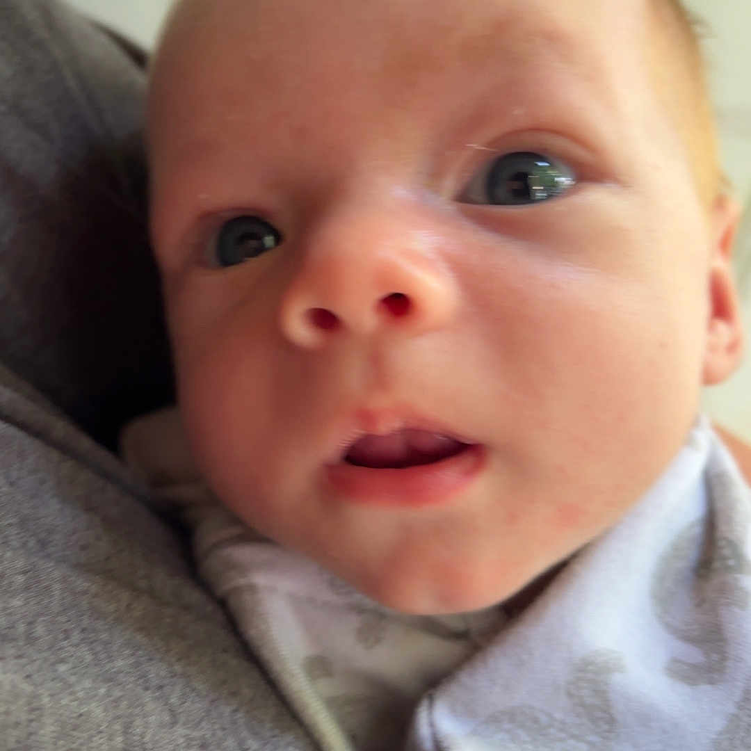 Preston joined the competition — help win amazing prizes! baby, infant, face, eyes, blanket, clothing, person, closeup, newborn, expression, skin, head, portrait, cute, indoors, soft, young, human, child, curious