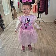Ines participe au concours pour gagner de l'argent avec cette photo : child, girl, toddler, smile, minnie_mouse, mouse_ears, bow, pink_dress, tutu, costume, pink_shoes, indoor, wood_floor, coat_rack, jackets, doorway, stroller, portrait, happy, playful