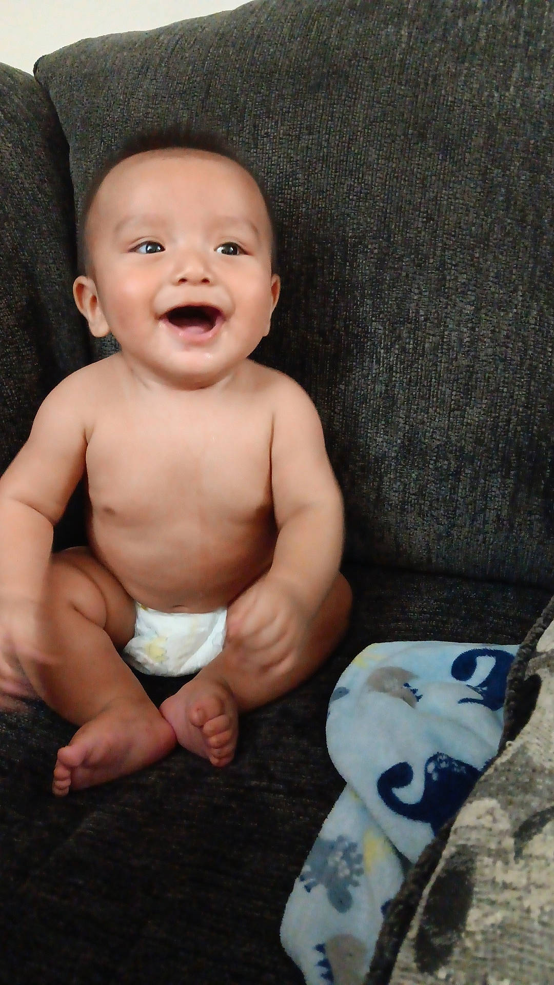 Dakari is registered to the contest to win money with this photo: baby, babylaughing, chair, clothing, couch, cushion, diaper, face, furniture, happy, head, homedecor, laughing, newborn, pants, person, photography, portrait, sitting, smile