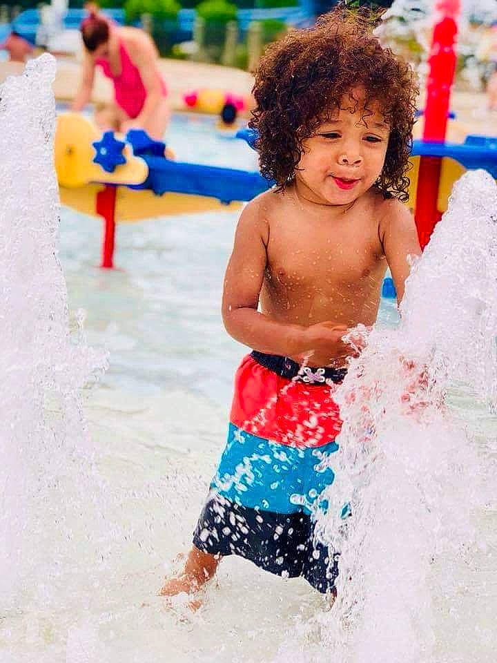 Izaiah is registered to the contest to win money with this photo: amusement_park, child, fun, leisure, nonbuilding_structure, park, person, play, recreation, smile, summer, swimwear, toddler, trunk, vacation, water, water_park