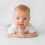 Charlie joined the competition — help win amazing prizes! baby, infant, blue_eyes, smile, white_clothing, cute, soft_light, portrait, hands, skin, face, child, lying_down, closeup, innocent, adorable, young, human, expression, background