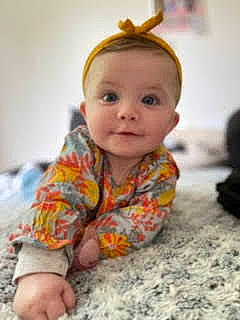 Elly participe au concours pour gagner de l'argent avec cette photo : baby, baby_toddler_clothing, cheek, child, chin, close_up, comfort, face, flooring, fun, head, iris, nose, pattern, person, product, sitting, skin, sleeve, toddler