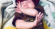 Christina joined the competition — help win amazing prizes! arm, baby, blanket, child, close_up, cozy, cute, face, hand, headwear, indoors, infant, maroon_bow, newborn, peaceful, polka_dot_clothing, resting, sleeping, soft_texture, yellow_tutu