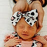 newborn, baby, infant, headband, bow, hands, pink_clothing, patterned, sleeping, smile, closeup, face, cute, soft_light, portrait, peaceful, child, newborn_baby, toddler, baby_girl