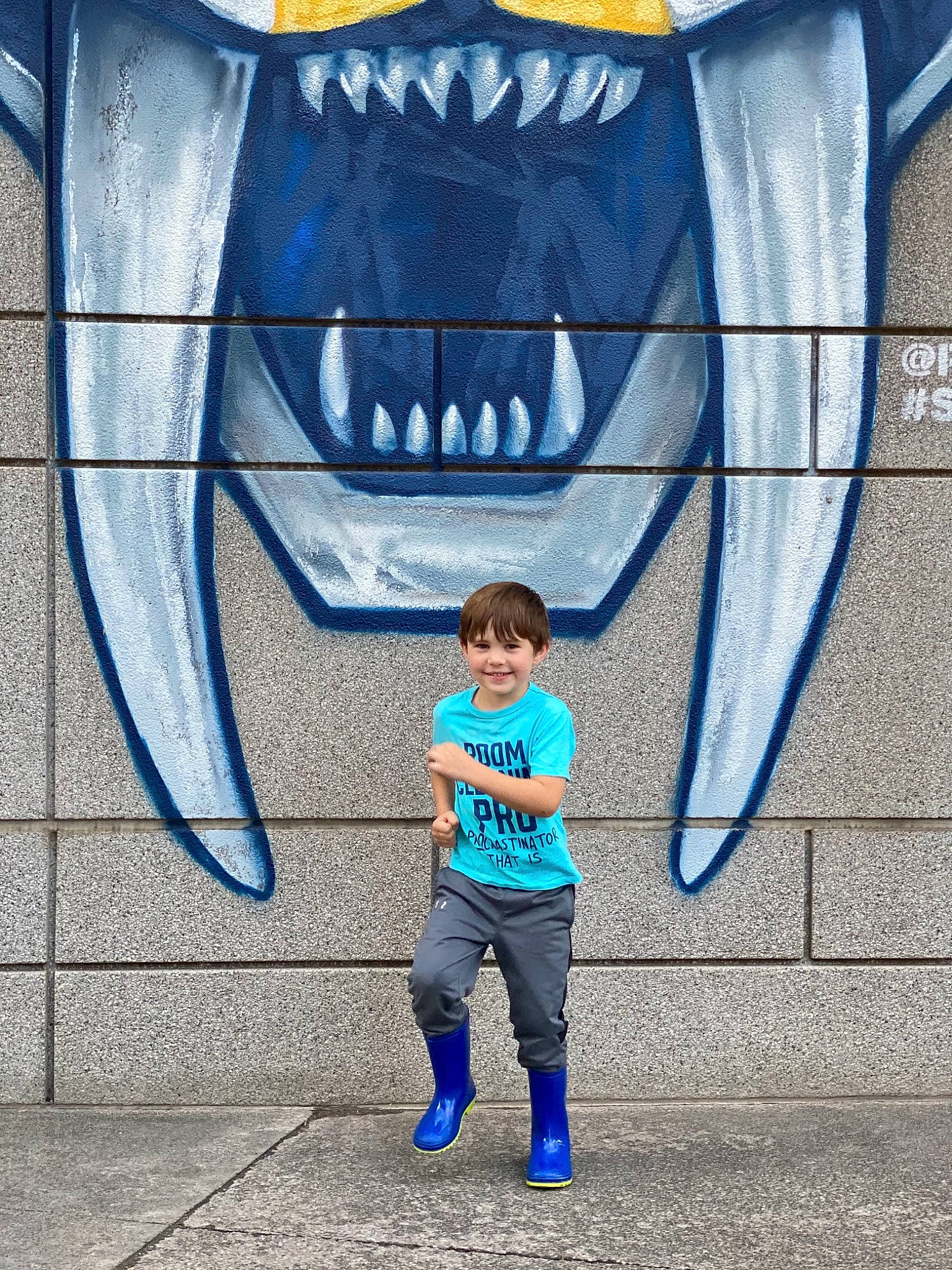 Zayne is registered to the contest to win money with this photo: art, azure, blue, electric_blue, eye, fish, font, gesture, graffiti, human, infrastructure, joy, mouth, painting, person, photograph, public_space, shark, snapshot, standing