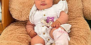Arzugul is registered to the contest to win money with this photo: baby, teddy_bear, plush_toy, pink_bow, headband, white_outfit, sitting, grass, toy, child, cute, soft, indoor, comfort, smiling, infant, legs, feet, pacifier_clip, bracelet