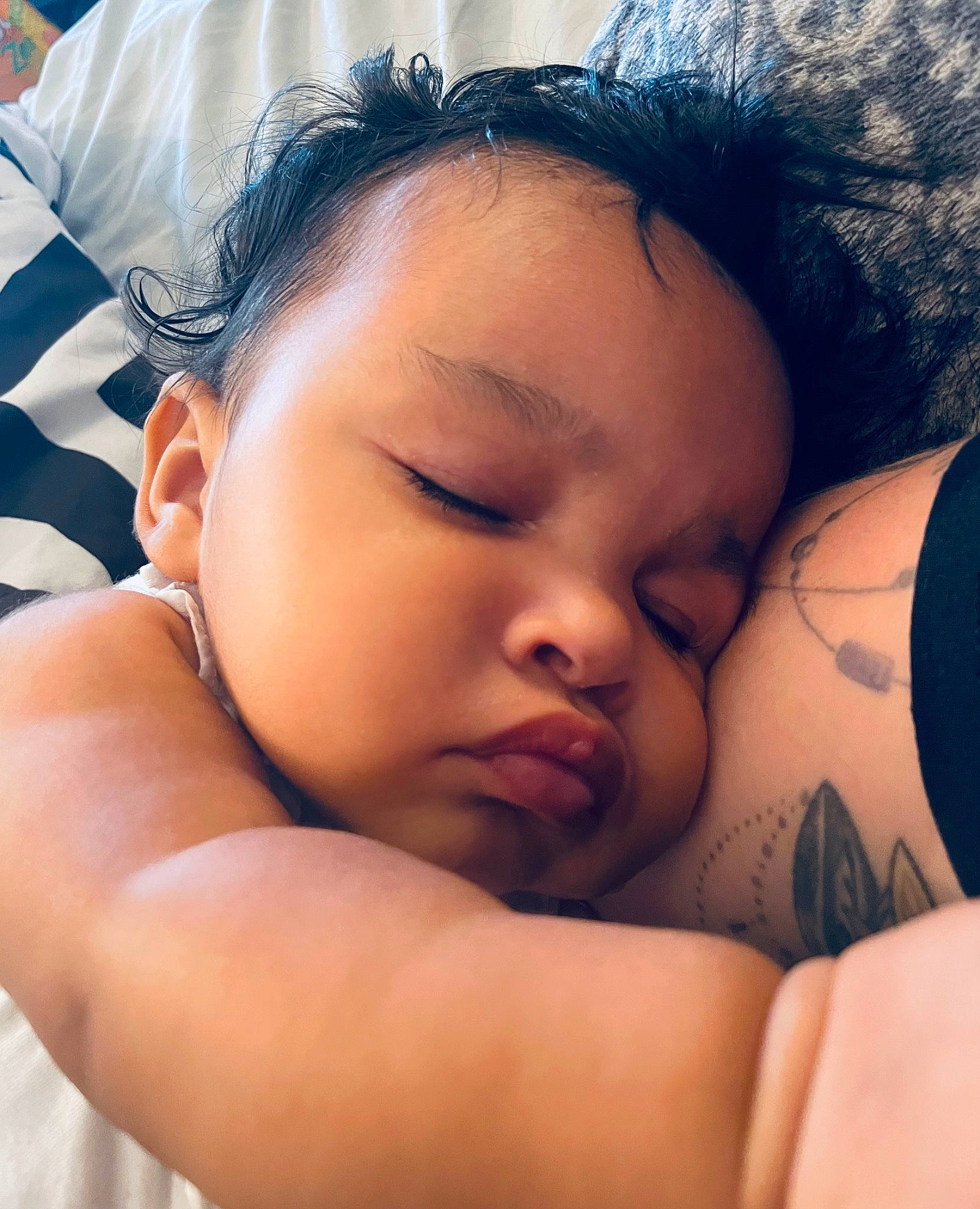Jocelyn is registered to the contest to win money with this photo: baby, baby_sleeping, black_hair, chin, comfort, eye, eyebrow, eyelash, facial_expression, finger, flash_photography, gesture, happy, lip, mouth, muscle, nose, person, skin, textile