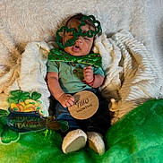Amani joined the competition — help win amazing prizes! baby, infant, green_clothing, shamrock_glasses, bow_tie, wooden_sign, two_months, blanket, cozy, st_patricks_day, decorations, shamrocks, gold_coins, pacifier, socks, cute, celebration, portrait, holiday, sitting
