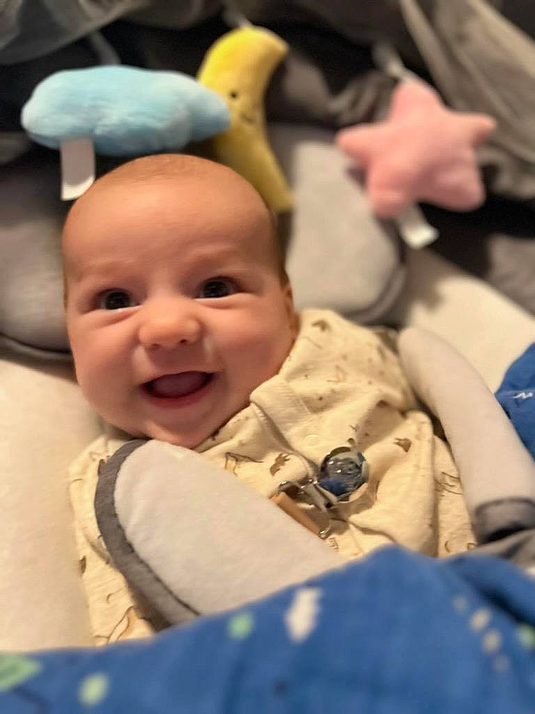 Nathan is registered to the contest to win money with this photo: baby, cheek, child, comfort, event, facial_expression, fun, gesture, happy, hat, laugh, person, room, smile, thumb, toddler