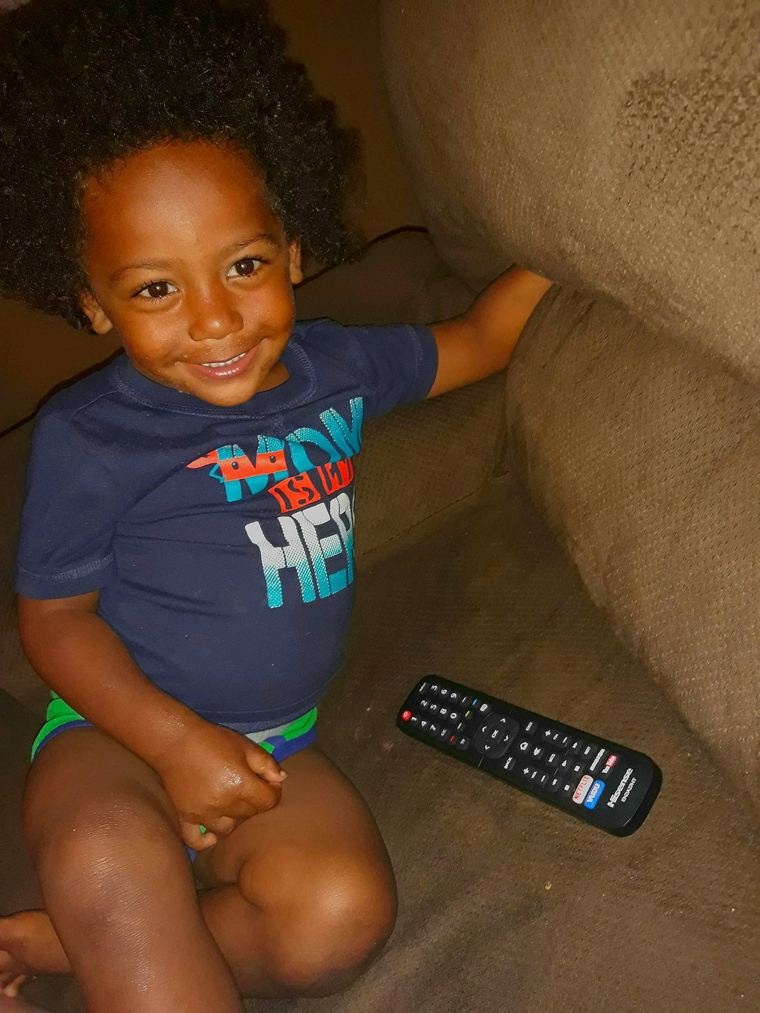 Kareem is registered to the contest to win money with this photo: arm, child, electronic_device, finger, joy, leg, person, skin, smile, technology, thigh, toddler