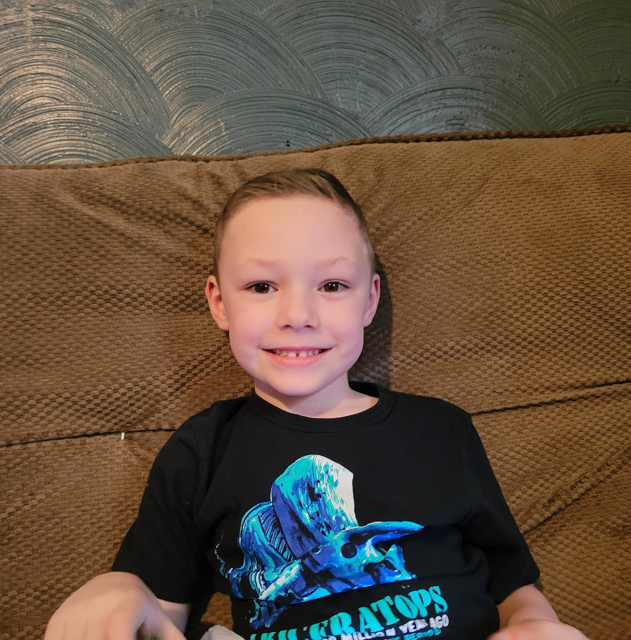 Braydan joined the competition — help win amazing prizes! child, comfort, cool, couch, electric_blue, flash_photography, flooring, fun, happy, human_body, joy, laugh, pattern, person, portrait_photography, sitting, sleeve, smile, t_shirt, toddler