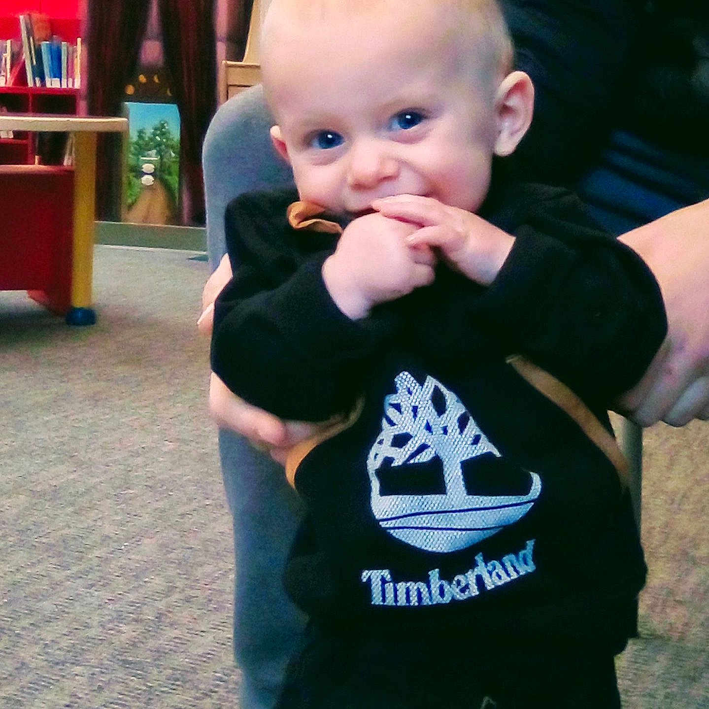 Braxten is registered to the contest to win money with this photo: baby, bodypart, chair, clothing, couch, cutlery, face, finger, furniture, hand, head, indoors, jeans, pants, person, photography, portrait, shirt, spoon, t_shirt