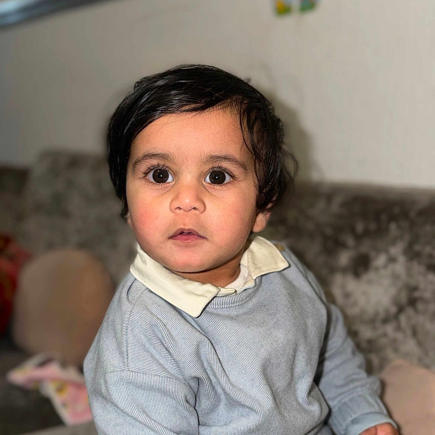 Ranfateh joined the competition — help win amazing prizes! big_eyes, casual_clothing, child, collared_shirt, couch, curly_hair, cute, expression, face, home_interior, indoors, looking_at_camera, person, portrait, seated, skin, soft_lighting, sweater, toddler, young_child