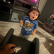 Giovanni joined the competition — help win amazing prizes! toddler, child, boy, cap, striped_shirt, construction_truck, expression, surprised, hand, finger_splint, chair, living_room, floor, television, furniture, plastic_storage_bin, toy, person, indoors, casual