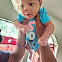 baby, child, person, indoor, hands, clothing, headband, onesie, window, curtain, light, skin, face, expression, arms, legs, holding, sparkle, closeup, playing