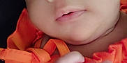 Tay'Lynn joined the competition — help win amazing prizes! baby, close_up, face, hand, orange_clothing, infant, cute, skin, portrait, newborn, child, person, expression, young, soft_light, indoors, human, small_hand, clothing, baby_face