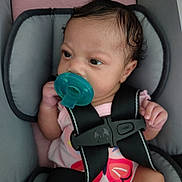 Tay'Lynn joined the competition — help win amazing prizes! baby, infant, pacifier, car_seat, seatbelt, child, pink_clothing, butterfly_design, curly_hair, close_up, indoors, seat, straps, sitting, young_child, cute, secure, hand, face, portrait