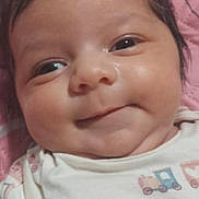 Tala joined the competition — help win amazing prizes! baby, browser_screenshot, child, close_up, cute, eyes, face, hair, happy, head, indoors, infant, lying_down, musical_print, pink_blanket, portrait, smartphone, smiling, website, white_clothing