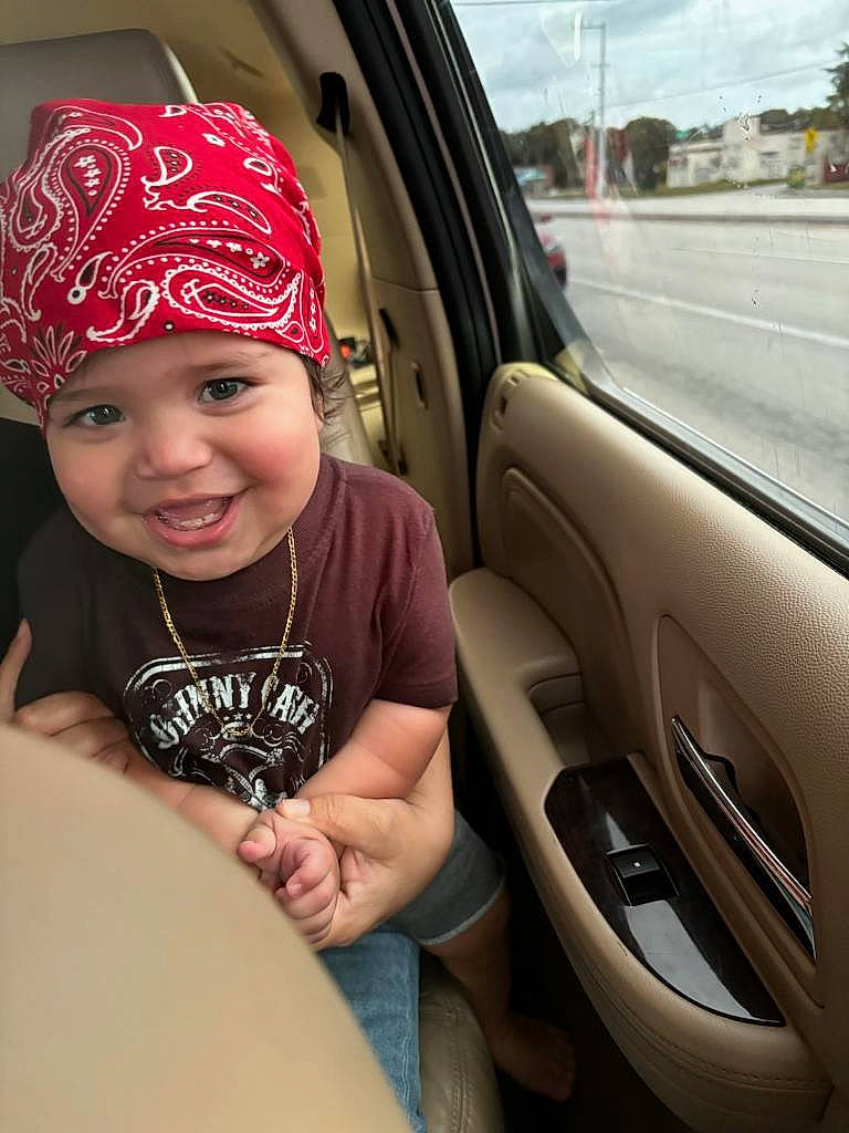 Isaiah is registered to the contest to win money with this photo: auto_part, automotive_design, automotive_exterior, automotive_lighting, automotive_window_part, baseball_cap, cap, car, car_seat, family_car, fashion_accessory, happy, headwear, helmet, joy, motor_vehicle, person, personal_protective_equipment, smile, steering_wheel