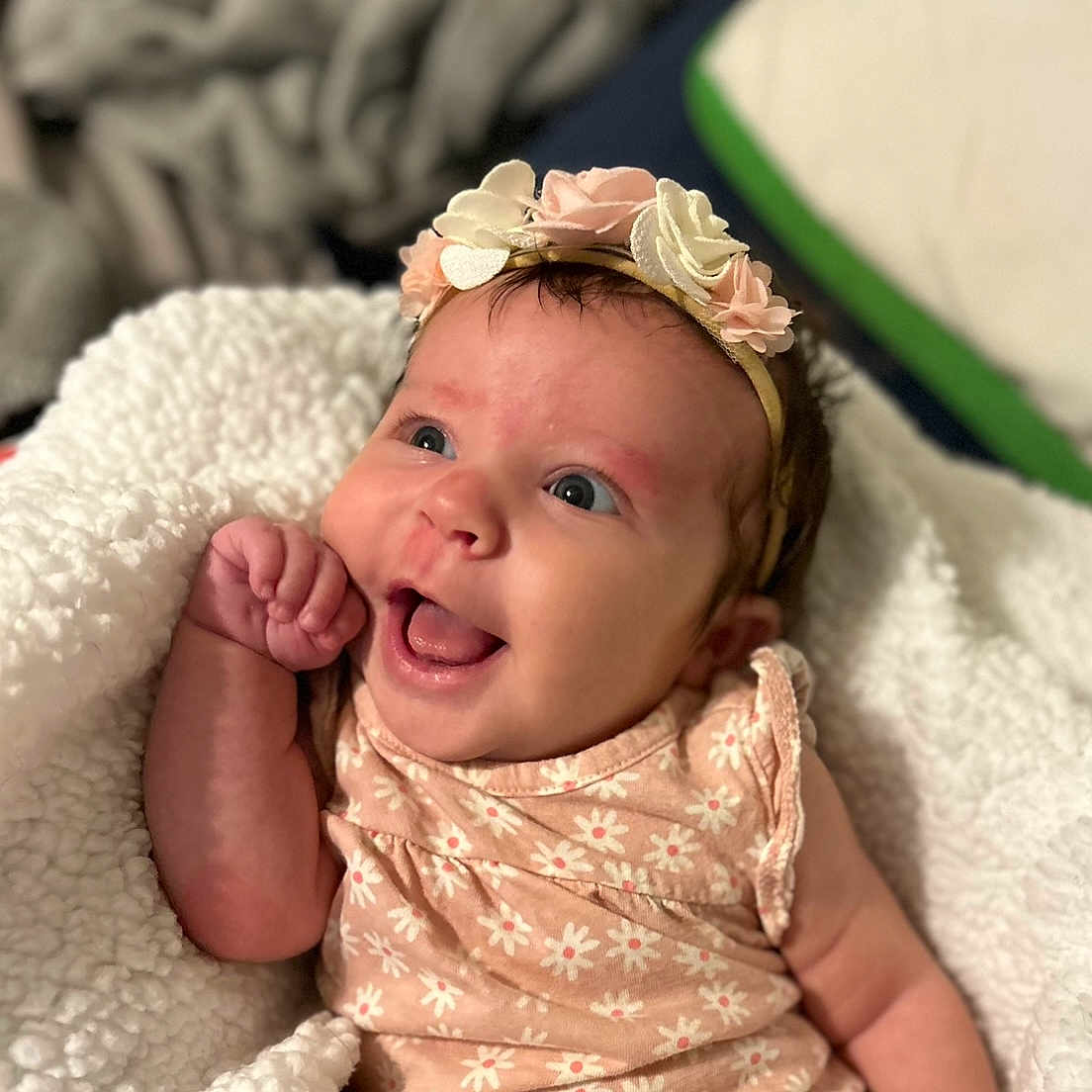 Tahlia is registered to the contest to win money with this photo: accessories, baby, babylaughing, blanket, bodypart, clothing, dress, face, finger, hand, happy, hat, head, laughing, newborn, person, photography, portrait, quilt, smile