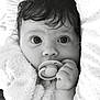 baby, infant, pacifier, towel, close_up, black_and_white, face, hand, curly_hair, expression, portrait, cute, child, newborn, sleepy, soft_texture, wrapped, indoors, skin, eyes