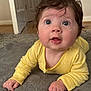 Mia joined the competition — help win amazing prizes! baby, child, infant, yellow_clothing, laying_down, blanket, indoors, soft_texture, curious_expression, face, hand, skin, hair, wide_eyes, cute, person, toddler, portrait, closeup, floor
