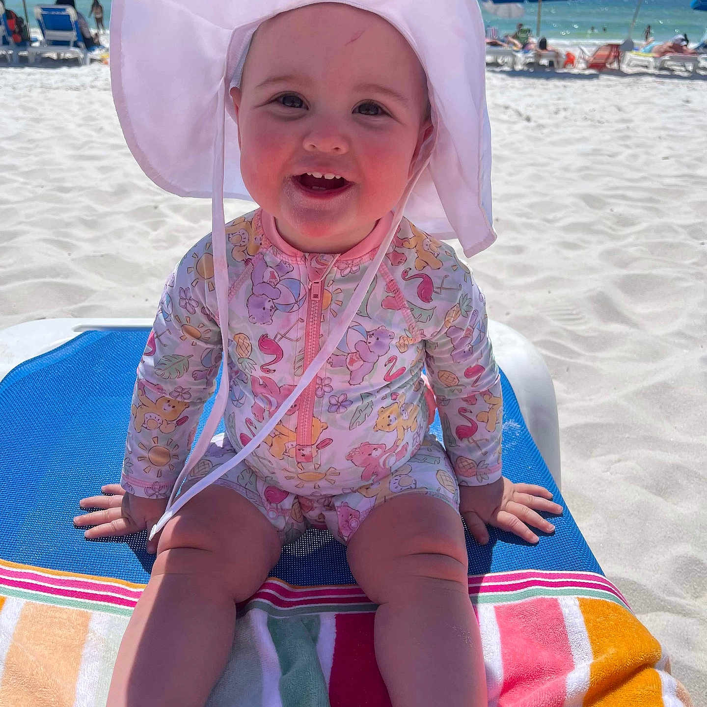 Adelynn joined the competition — help win amazing prizes! architecture, baby, beach, beachwear, building, clothing, coast, face, hat, head, nature, outdoors, person, photography, portrait, sea, shelter, shoreline, summer, water