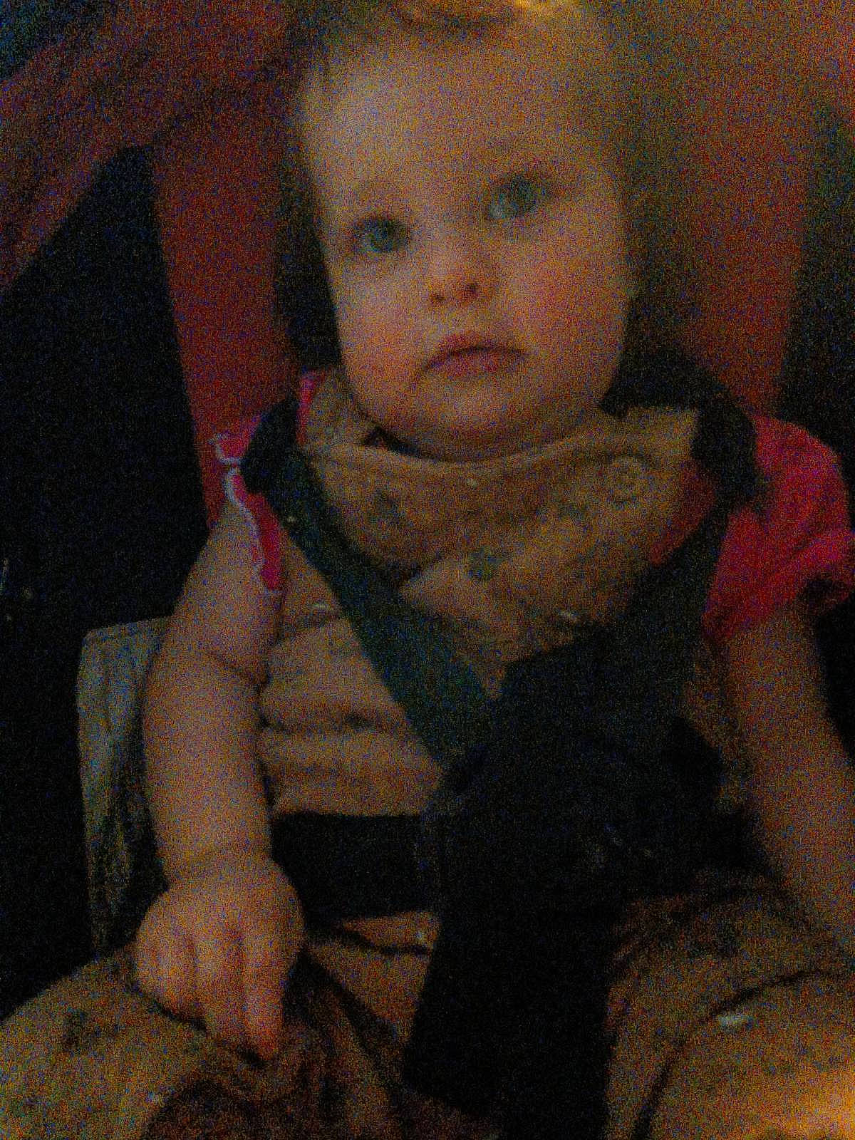 Gracie is registered to the contest to win money with this photo: arm, baby, baby_carriage, baby_toddler_clothing, cheek, child, comfort, eyebrow, finger, hand, iris, lap, lip, mouth, nose, person, sitting, skin, sleeve, thumb