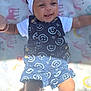 baby, headband, smile, denim, overall, white_socks, blanket, rainbow, unicorn, infant, cute, happy, child, clothing, pattern, portrait, lying_down, sunlight, baby_girl, outdoor