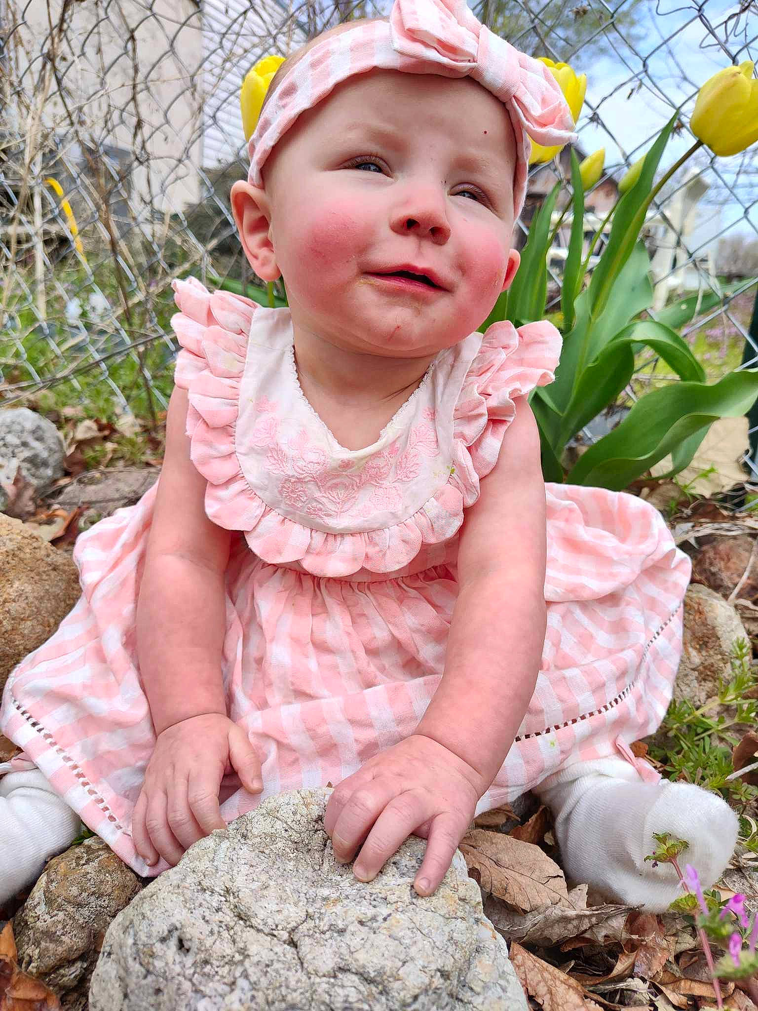 Charolette is registered to the contest to win money with this photo: baby, baby_toddler_clothing, child, clothing, fashion_accessory, fun, garden, grass, happy, headwear, pattern, people_in_nature, person, photograph, pink, plant, sitting, skin, sleeve, smile