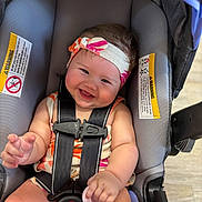 Lesley is registered to the contest to win money with this photo: baby, car_seat, child, clothing, eyes, face, floor, hand, happy, headband, indoor, infant, mouth, pacifier, seat_belt, security, sitting, skin, smile, straps