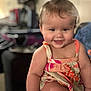 arm, baby, blurred_background, child, colorful, cute, dress, face, hair, happy, indoors, legs, person, playful, portrait, sitting, skin, smile, toddler, young