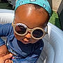 Sohan a rejoint le concours — aidez-le/la à gagner de superbes lots ! baby, bandana, blue_clothing, child, cute, face, hand_holding, headwear, inflatable_pool, outdoor, person, playing, pool, skin, summer, sunglasses, sunlight, sunny, toddler, water