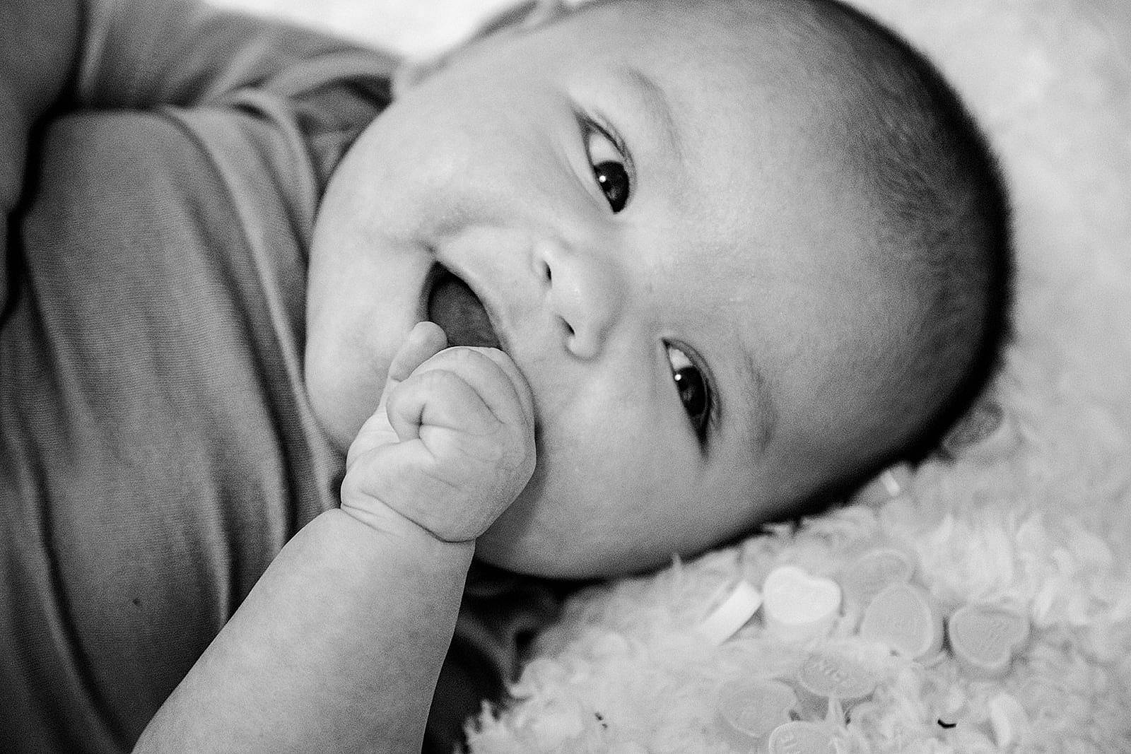 Jess is registered to the contest to win money with this photo: arm, baby, black_and_white, cheek, ear, eye, eyelash, face, flash_photography, gesture, hand, happy, iris, lip, mouth, nose, person, skin, smile, style