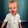 toddler, child, smiling, happy, blonde_hair, blue_eyes, knitted_clothing, white_shirt, portrait, indoors, cute, baby, person, young_child, standing, short_sleeves, buttoned_shirt, joyful, background, human