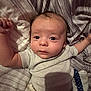 Elias joined the competition — help win amazing prizes! baby, infant, bed, blanket, clothing, striped, face, looking, arms, eyes, head, person, sleepwear, resting, indoors, cute, newborn, young, soft, comfort