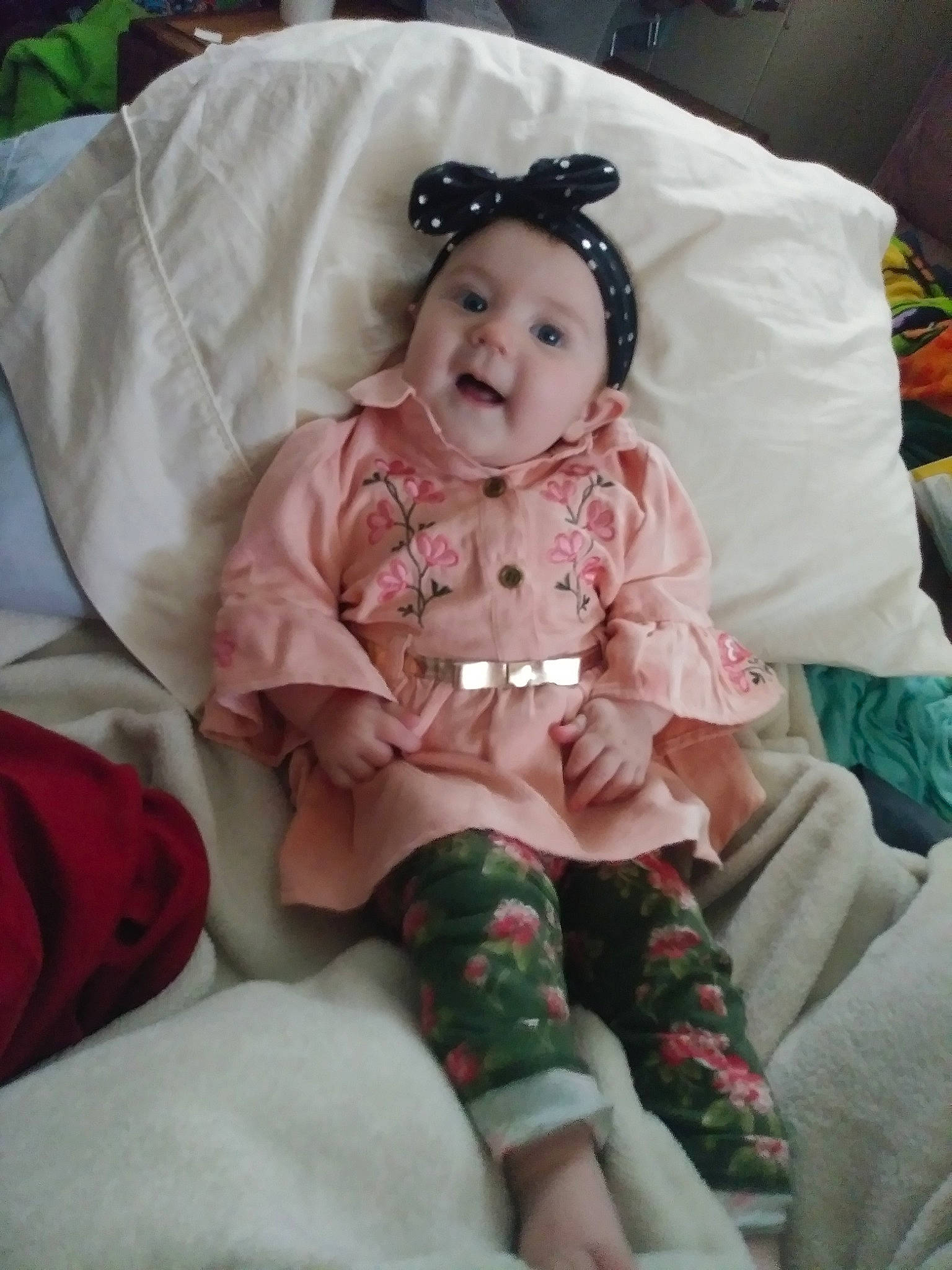 Kaelynn is registered to the contest to win money with this photo: cheek, child, day, eye, finger, girl, hair_accessory, head, infant, iris, mouth, person, pink, product, skin, textile, toddler