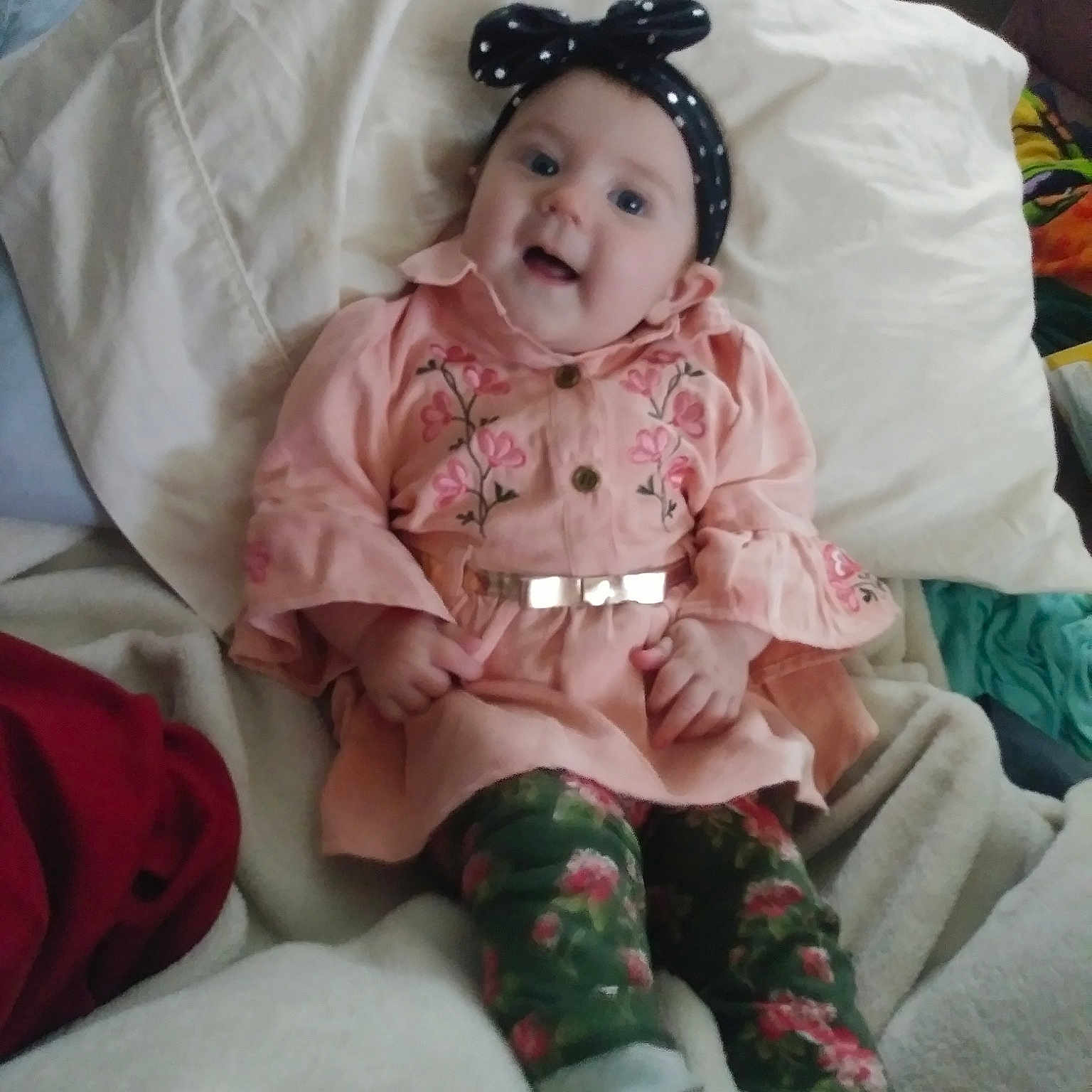 Kaelynn is registered to the contest to win money with this photo: cheek, child, day, eye, finger, girl, hair_accessory, head, infant, iris, mouth, person, pink, product, skin, textile, toddler