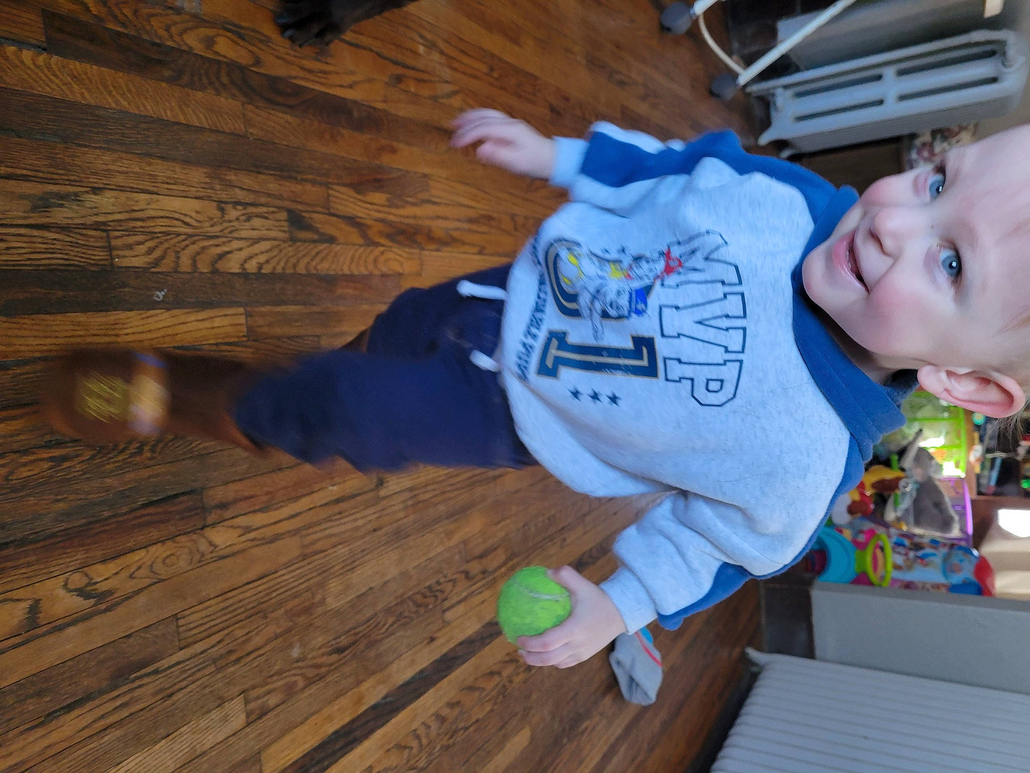 Kai is registered to the contest to win money with this photo: baby, baby_toddler_clothing, child, electric_blue, flooring, fun, happy, hardwood, joy, laminate_flooring, lumber, person, plank, plywood, room, smile, t_shirt, toddler, varnish, wood
